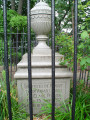 Funeral urn on pedestal marking grave