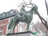 Equestrian figure (over life-size) with integral plinth on a pedestal that rests on a base that allows the monument to sit at the top of a staircase