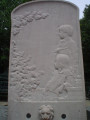 Stele with curved top; on front a bas relief over a shell basin with lion-head spouting fountain