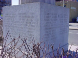 Fluted rostral column topped with an eagle and inscribed with honor roll, on pedestal with bronze plaque