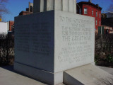 Fluted rostral column topped with an eagle and inscribed with honor roll, on pedestal with bronze plaque