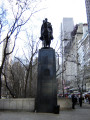 Equestrian statue (heroic scale) on pedestal with four coats of arms