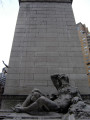 Pylon fountain embellished with colossal group, nine figures (heroic scale), and frieze; three plaques (two large, one small); four gate houses, each with a door and three low reliefs