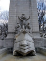 Pylon fountain embellished with colossal group, nine figures (heroic scale), and frieze; three plaques (two large, one small); four gate houses, each with a door and three low reliefs