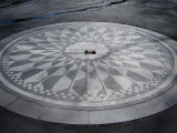 Mosaic roundel with starburst design set in pavement, plaque set in rock outcropping about a hundred yards east of roundel