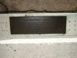 Obelisk supported by bronze crabs at four corners of base, on a block on a square terrace, plaques