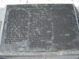 Obelisk supported by bronze crabs at four corners of base, on a block on a square terrace, plaques