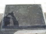 Obelisk supported by bronze crabs at four corners of base, on a block on a square terrace, plaques