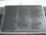 Obelisk supported by bronze crabs at four corners of base, on a block on a square terrace, plaques