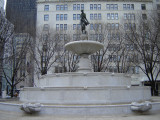 Fountain with sculptures: five basins in a stepped pattern support at their highest point a sixth, shell-form basin holding a standing female figure (over life-size); two rams-head horns of plenty  flank the third basin