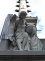 Standing figue (colossal scale) on rostral column on pedestal, base, and plinth; pedestal figure of a winged youth examining a globe; two bas-reliefs on base