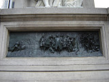 Standing figue (colossal scale) on rostral column on pedestal, base, and plinth; pedestal figure of a winged youth examining a globe; two bas-reliefs on base