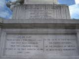 Standing figue (colossal scale) on rostral column on pedestal, base, and plinth; pedestal figure of a winged youth examining a globe; two bas-reliefs on base