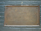 Two plaques on west side of fieldhouse