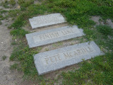 2 vertical poles on separate bases, 3 granite markers