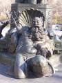 Group of three standing figures (heroic scale) on pedestal adorned with three reclining figures (heroic scale), in basin with rockwork coping