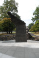 Over lifesized figure of soldier on mound, with separate mountainscape and honor-roll behind