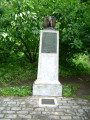 Eagle on integral plinth on stele on base, two plaques (one mounted on stele, one in ground before stele)