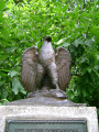 Eagle on integral plinth on stele on base, two plaques (one mounted on stele, one in ground before stele)