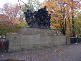 Group of seven figures (over life-size) with integral plinth, on a pedestal