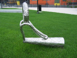 Sculpture representing casting loop on fishing poles, stands fully upright