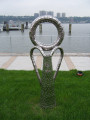 Sculpture representing casting loop on fishing poles, tilted slightly to the ground