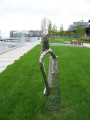 Sculpture representing casting loop on fishing poles, tilted slightly to the ground