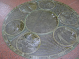 Five medallions embedded at different locations in the walkways