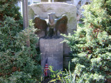 Stele with eagle in front, plaque attached at back, two smaller incised steles at side with plaques at back