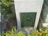 Stele with eagle in front, plaque attached at back, two smaller incised steles at side with plaques at back