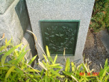 Stele with eagle in front, plaque attached at back, two smaller incised steles at side with plaques at back