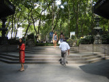 Square paved with flagstones with broad stairway enclosed by two sidewalls, top stones inscribed on stairside