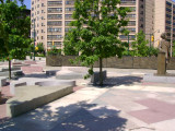 Heroic scale bronze figure, bronze fountain wall, and decorative paving and seating blocks