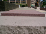 Heroic scale bronze figure, bronze fountain wall, and decorative paving and seating blocks