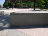 Heroic scale bronze figure, bronze fountain wall, and decorative paving and seating blocks