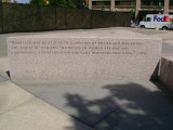 Heroic scale bronze figure, bronze fountain wall, and decorative paving and seating blocks