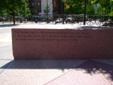 Heroic scale bronze figure, bronze fountain wall, and decorative paving and seating blocks