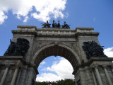 Triumphal arch; bas-relief figures in spandrels on south face; seal of city of Brooklyn and seal of New York state in spanrels on north face; sixteen medallions, four on each of the pier stages at south and north faces