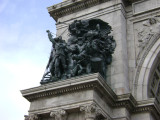 Triumphal arch; bas-relief figures in spandrels on south face; seal of city of Brooklyn and seal of New York state in spanrels on north face; sixteen medallions, four on each of the pier stages at south and north faces