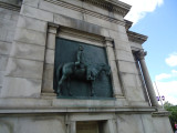 Triumphal arch; bas-relief figures in spandrels on south face; seal of city of Brooklyn and seal of New York state in spanrels on north face; sixteen medallions, four on each of the pier stages at south and north faces