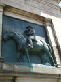 Triumphal arch; bas-relief figures in spandrels on south face; seal of city of Brooklyn and seal of New York state in spanrels on north face; sixteen medallions, four on each of the pier stages at south and north faces