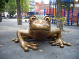 Figural sculpture of a mother and baby coqui frog