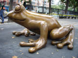 Figural sculpture of a mother and baby coqui frog