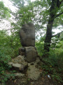 Large boulder resting on several medium-sized boulders, supported by about a dozen small boulders