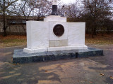 Flagpole base, ornamental pedestal with circular relief sculpture