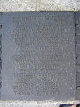 Group of three doughboy figures (over life-size) with integral plinth on a low base that rests on a circular pedestal; twenty plaques facing upward and carrying the names of the dead surround  the group