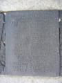 Group of three doughboy figures (over life-size) with integral plinth on a low base that rests on a circular pedestal; twenty plaques facing upward and carrying the names of the dead surround  the group