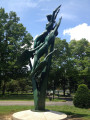 Group of two upright figures (heroic scale), one male,one female, supported by three swans in flight, attached to upright spikes, on a circular pedestal