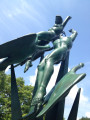 Group of two upright figures (heroic scale), one male,one female, supported by three swans in flight, attached to upright spikes, on a circular pedestal