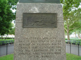 Figure (heroic scale) on integral plinth, pedestal with four recessed relief plaques